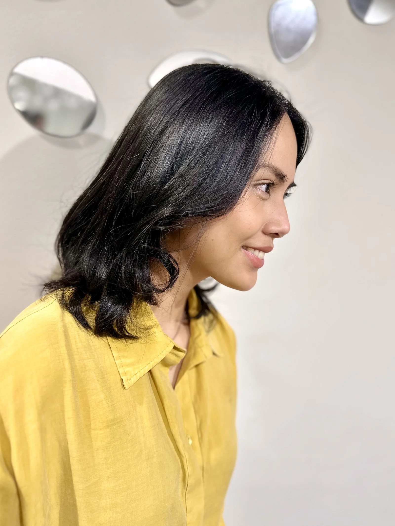 Dark medium wavy hair, smiling