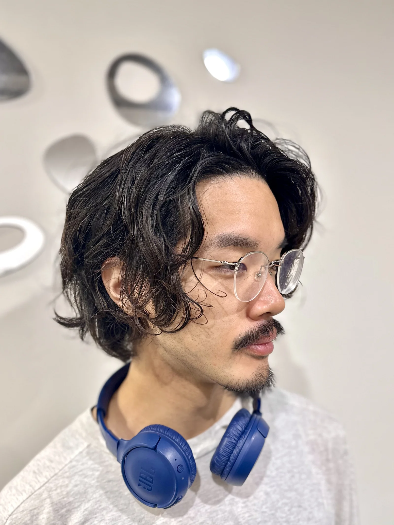 Men's dark wavy long hair with glasses